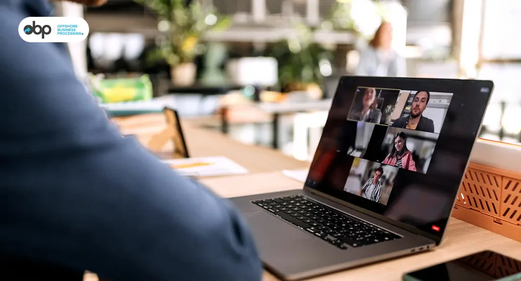 Client video conferencing with offshore team on laptop screen